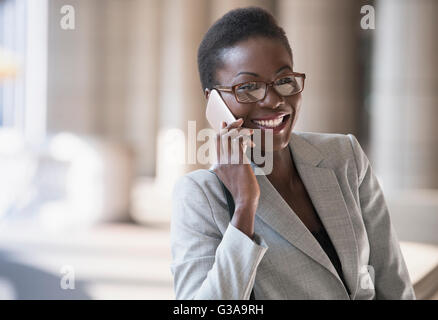 Smiling corporate businesswoman talking on cell phone Stock Photo