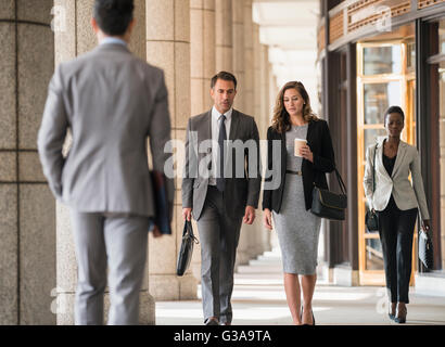 Corporate business people walking in cloister Stock Photo