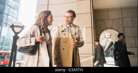 Corporate businessman and businesswoman talking outdoors Stock Photo