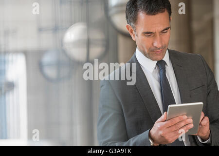 Corporate businessman using digital tablet outdoors Stock Photo