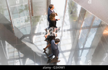 Corporate business people walking in modern lobby Stock Photo