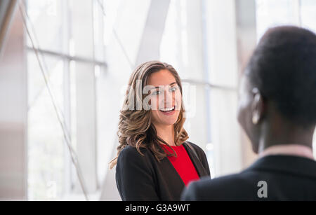 Smiling corporate businesswomen talking Stock Photo