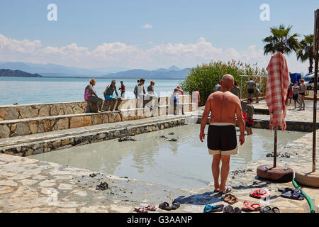 People taking a mud bath, thermal spa on Lake Koycegiz, Sultaniye, near Dalyan, Mugla Province, Turkey. Stock Photo