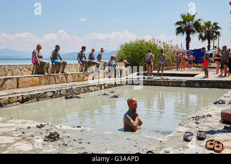 People taking a mud bath, thermal spa on Lake Koycegiz, Sultaniye, near Dalyan, Mugla Province, Turkey. Stock Photo