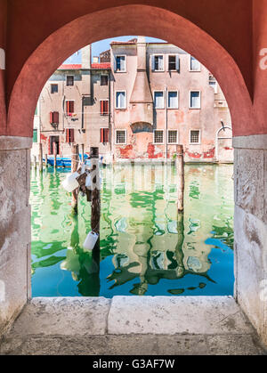 Chioggia glimpse from the arcades along the canals. Stock Photo