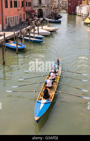 Venice, Italy - May 20, 2016: Female crew is training on a rowing boat in Venice. Stock Photo