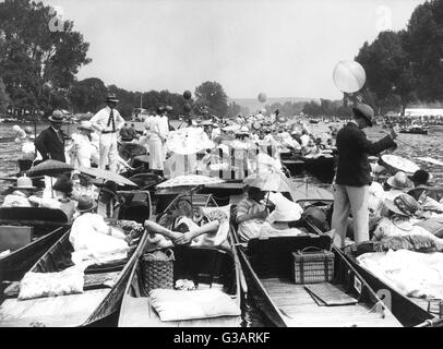 People at a crowded regatta on the River Thames Stock Photo