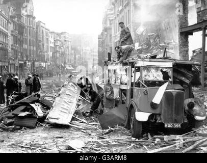 Blitz in London -- aftermath of bombing, with a row of ruined buildings ...