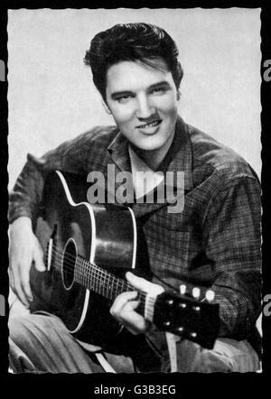 ELVIS PRESLEY  American pop singer, guitarist  and actor in musical films,  seen here with his guitar      Date: 1935 - 1977 Stock Photo