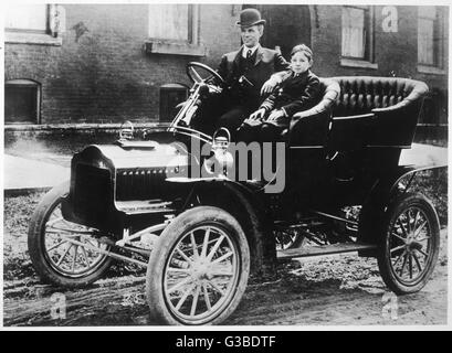 Henry Ford, the American motor  manufacturer, with his son  Edsel in one of the many  versions of the Model T.      Date: circa 1912 Stock Photo