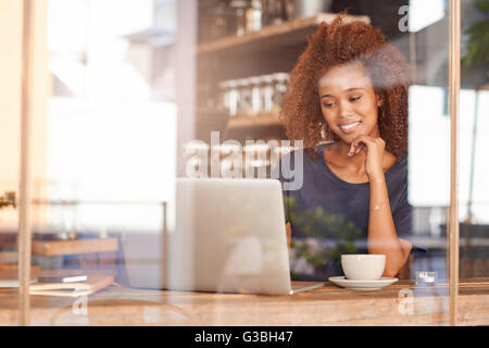 Working on her laptop at a cafe Stock Photo