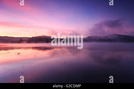 Fog at dawn over Lake Solina in the Bieszczady Mountains Stock Photo