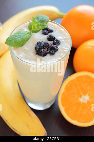 Smoothie with banana, orange and blueberries fruits Stock Photo