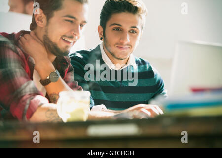 Young creative businessmen working at laptop in office Stock Photo