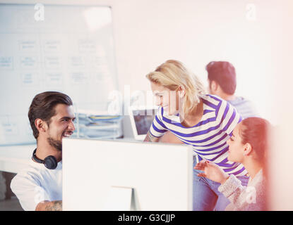 Creative young business people working at computer in office Stock Photo