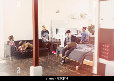 Young adult friends hanging out in loft apartment Stock Photo