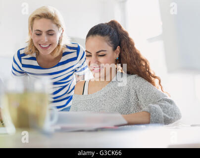 Creative young businesswomen reviewing paperwork Stock Photo