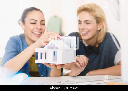 Young female architects assembling house model Stock Photo