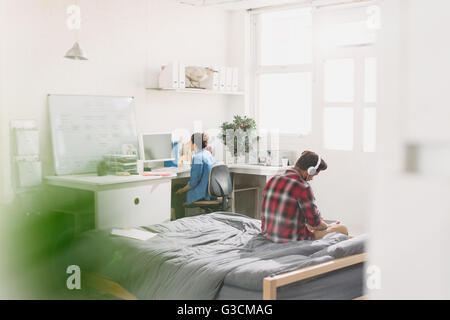 Young adults studying in apartment Stock Photo