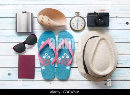 Vacation items, including sunglasses, and camera, on white wooden planks Stock Photo