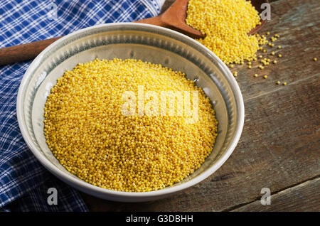 Organic millet in bowl on  wooden rustic table. Top view Stock Photo