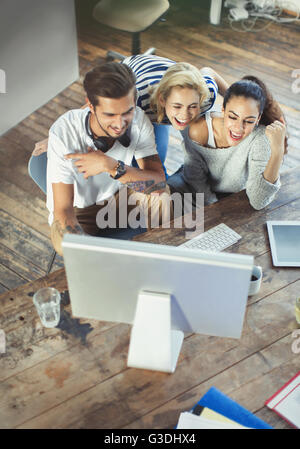 Young adult friends using computer Stock Photo