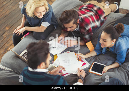 College students studying on bed Stock Photo