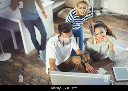 Creative young business people working at computer in office Stock Photo