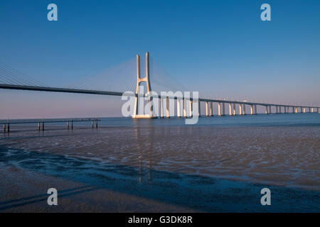 Vasco da Gama Bridge (Ponte Vasco da Gama) spans the Tagus River in Parque das Nacoes, Lisbon, Portugal Stock Photo