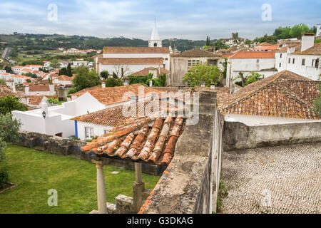 Scenic view across teracotta rooftops in historic town of Obidos, Estremadura, Portugal Stock Photo