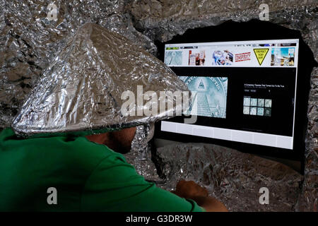 male conspiracy theory believer wearing tin foil hat Stock Photo