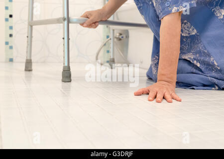 elderly woman falling in bathroom because slippery surfaces Stock Photo