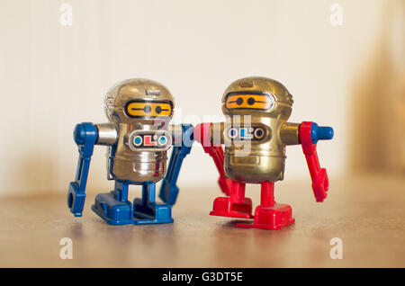 two small toy robots red and blue Stock Photo