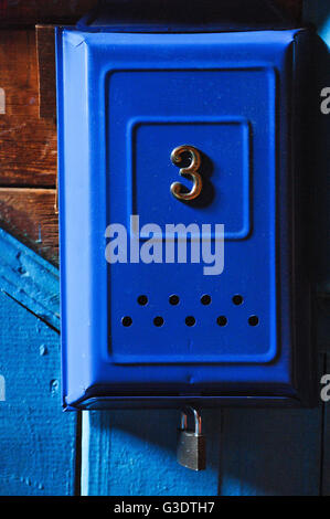 Number 3 on blue mailbox. Stock Photo