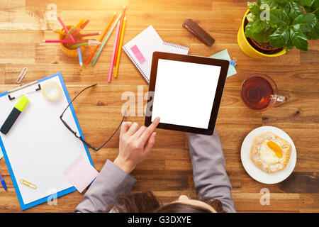 Detail of businessman hands holding blank tablet device. Modern office interior Stock Photo