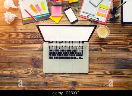 Aerial view of laptop with other modern electonic devices on desk. Modern hipster office interior Stock Photo