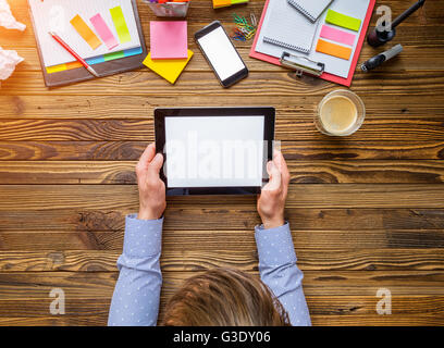 Detail of businessman hands holding blank tablet device. Modern office interior Stock Photo