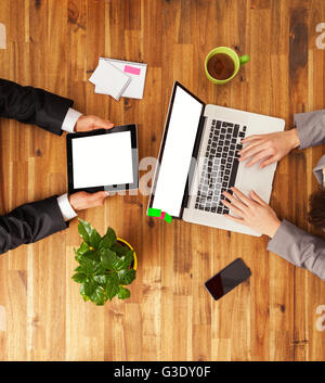 Detail of Man and woman working on laptop and tablet. Shot from above view. detail of modern hipster office Stock Photo