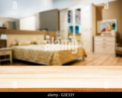 Wooden empty table in front of blurred bedroom Stock Photo