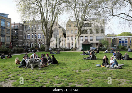 People relaxing in Hoxton Square in early spring 2016  East London, England UK  KATHY DEWITT Stock Photo