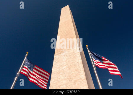 American flags at the Washington Monument, a tall obelisk within the National Mall in Washington, D.C, built to commemorate George Washington. Stock Photo