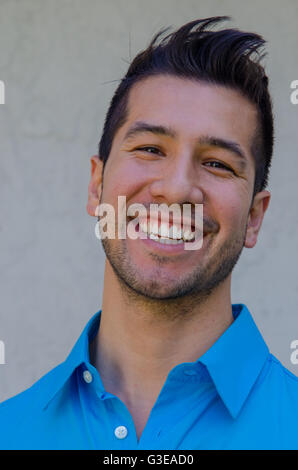 portrait of a handsome young Hispanic man smiling looking very happy