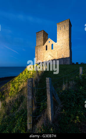 Reculver towers on the North Kent coast lit up at twilight. Stock Photo