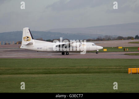 VLM Airlines Fokker 50 regional turbo-prop aircraft (OO-VLP) taxiing on Manchester International Airport tarmac. Stock Photo