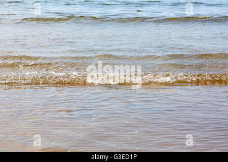 Little ripples in the sand from the sea on the beach Stock Photo