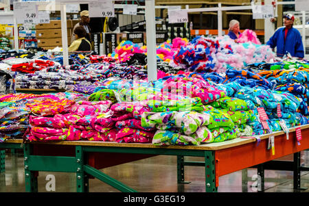 Brightly colored clothing on tables at a Costco Store in San Leandro California Stock Photo