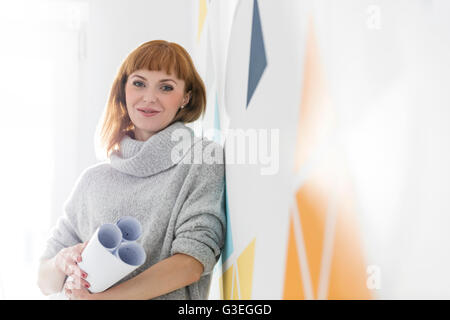 Portrait confident architect holding blueprints Stock Photo