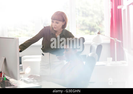 Businesswomen working at computer in office Stock Photo