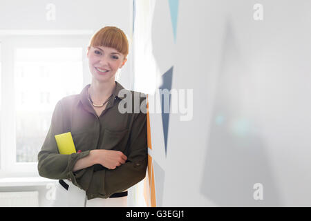Portrait confident businesswoman leaning on wall Stock Photo
