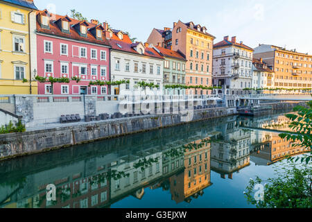 Various buildings in Ljubljana along the river. Reflections can be seen in the water Stock Photo